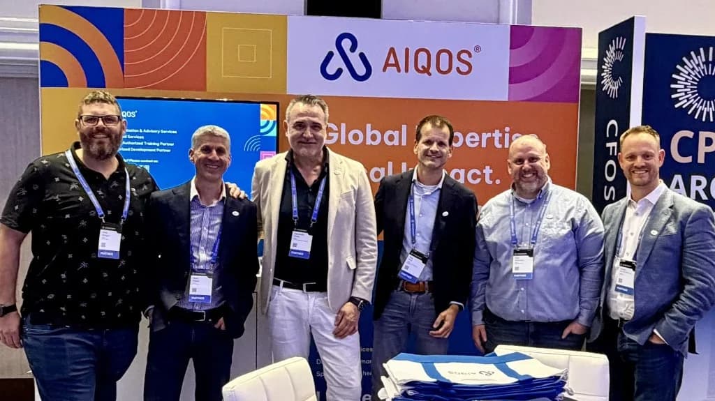 AIQOS OneStream consultants at an industry event